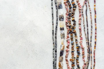 Precious and jewelry flat lay background. Lots of gemstones for necklace and bracelets, top view © 9dreamstudio