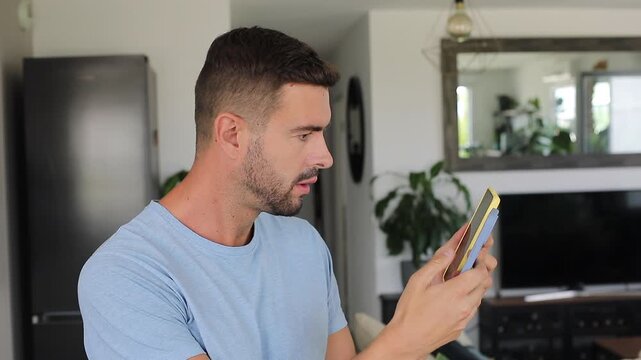 Overwhelmed man managing two smartphones simultaneously during stressful multitask day