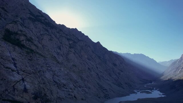 Evening sun rays illuminate rugged mountains above Osho Lakes in Kalam Valley, Hindu Kush, Khyber Pakhtunkhwa, Pakistan