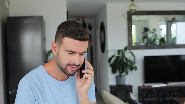 Nervous man answering phone call showing anxious expression and emotional concern