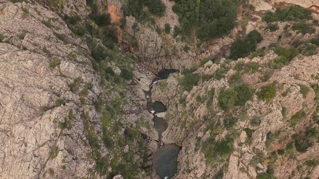 Rio Oridda River Flowing Through Piscina Irgas Waterfall In Sardinia, Italy. - aerial shot