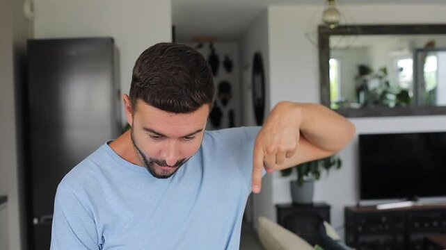 Man pointing down acting surprised