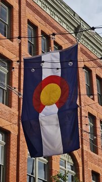Colorado State Flag Hanging Above Larimer Square in Downtown Denver Colorado USA, Vertical View