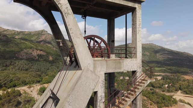 Concrete Headframe Of Pozzo Sartori, Prominent Landmark Within The Montevecchio Mining Complex In Sardinia, Italy. Aerial Close-up Shot