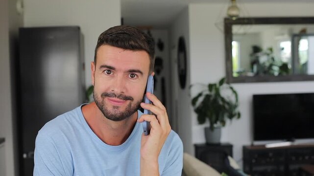 Nervous man answering phone call showing anxious expression and emotional concern