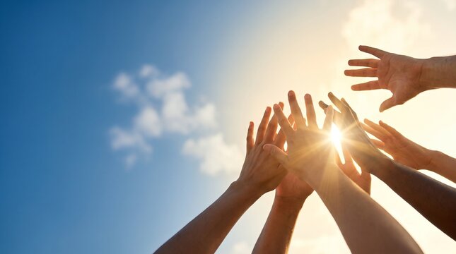 Diverse hands reaching up towards a bright sun in a clear blue sky, symbolizing unity and aspiration.