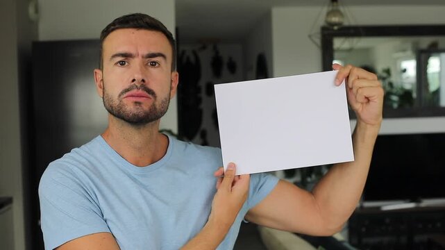 Serious man showing a white paper with space for copy