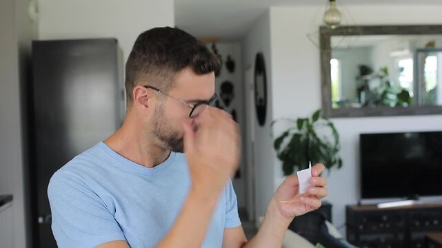 Man carefully cleaning his reading glasses with special wet wipe