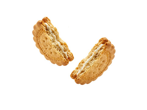 Two halves of a delicious cream-filled sandwich cookie floating against a transparent background
