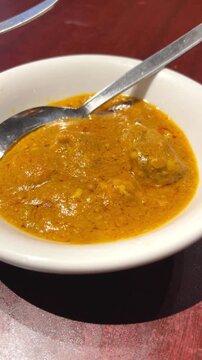 Traditional cow brain curry served for breakfast at a restaurant in Dhaka, Bangladesh. Popular local delicacy prepared with aromatic spices and authentic Bangladeshi flavors.