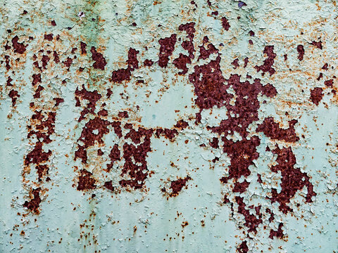 Rusty metal texture with peeling green paint background, old oxidized iron surface with corrosion and cracks