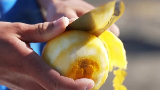 This detailed process shows someone carefully peeling a yellow citrus fruit using a sharp knife, then finely mincing the zest on a board and mixing it into raw ground meat with herbs.