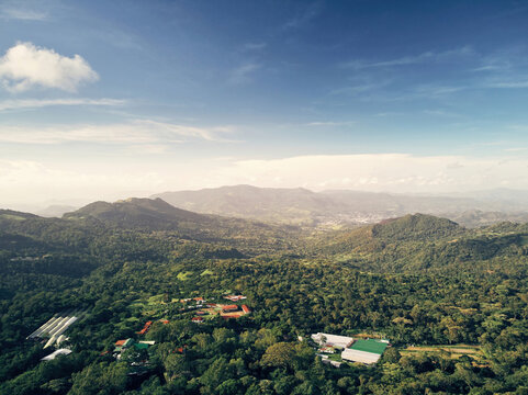 Aerial view of the Selva Negra mountain resort surrounded by dense tropical forests, rolling hills, and clear blue skies in Selva Negra, Matagalpa, Nicaragua.