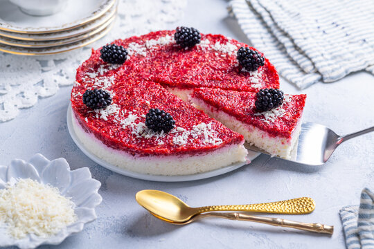 Refreshing no-bake coconut yogurt cake with vibrant berry topping and blackberries
