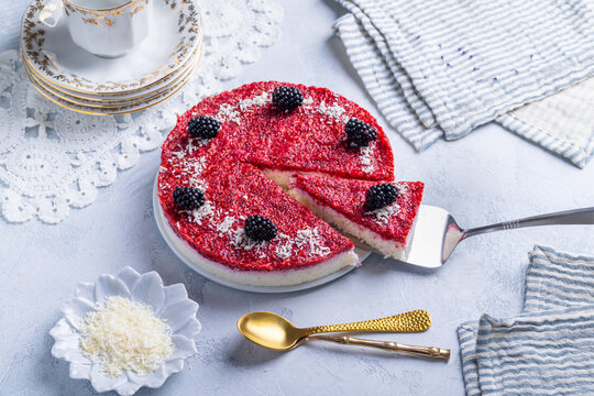 Refreshing no-bake coconut yogurt cake with vibrant berry topping and blackberries