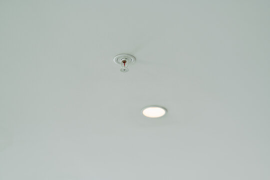 ceiling sprinkler installed and inactive in indoor setting with neutral mood and top-down view, noa, noa.