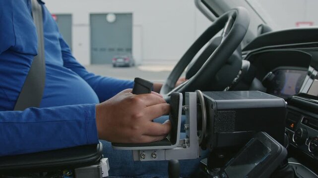 Adaptive driving hand controls and dashboard inside an accessible vehicle, used by a person with disability, close-up shot.