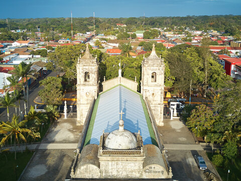 Aerial view of the Santiago Apostol Parish Church with its twin bell towers and metal roof, surrounded by the town of Jinotepe, Carazo, Nicaragua.