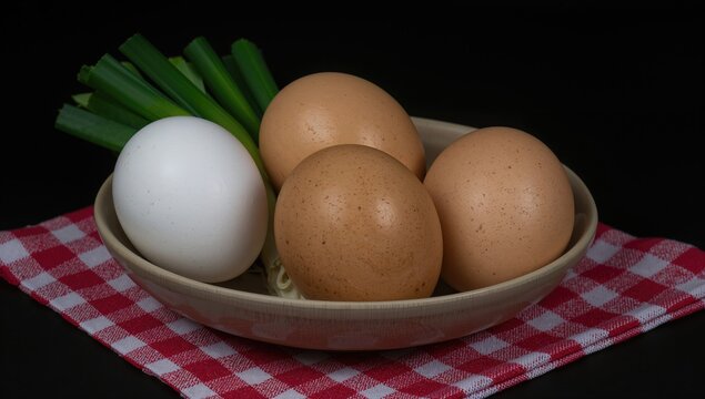Brown and White Eggs in a Bowl with Green Onions on a Red Checkered Cloth