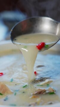 Close-up of milky white fish soup with thick soup