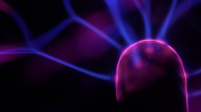 A close-up of a plasma ball coil that creates energy beams in shades of purple.