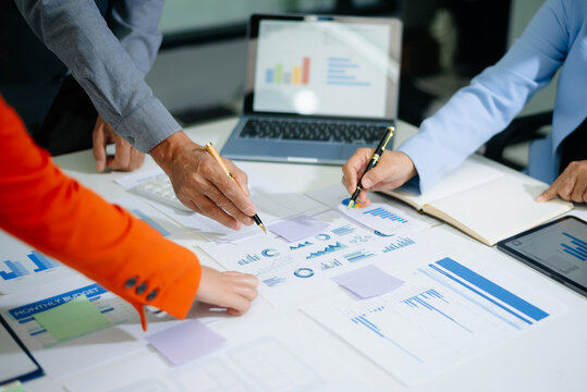 usiness People Talking Discussing with financial document data charts and graphs Team business meeting with smart phone