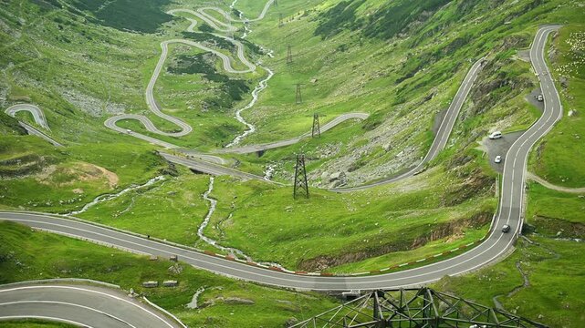 Panoramic view of Transfagarasan mountain road winding through Fagaras mountains in Romania.