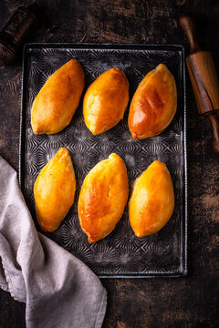 Traditional baked pies pirozhki with meat.