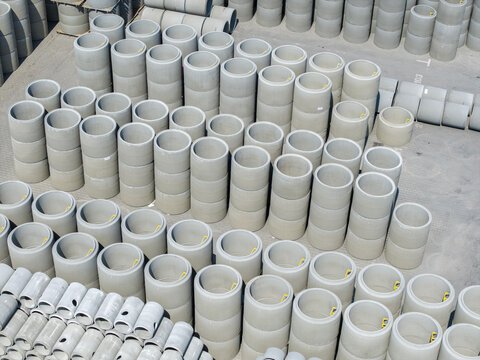 Aerial view of rows of stacked concrete pipes and precast elements in an industrial storage yard in Krakow, Lesser Poland Voivode, Poland.