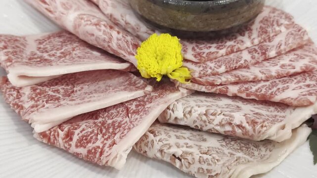 Close-up of premium A5 Wagyu beef slices arranged on a serving plate, highlighting exceptional marbling and elegant presentation for gourmet dining.