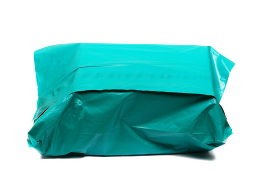 Parcel in cyan plastic bag isolated on white background, clipping path, design element, side view