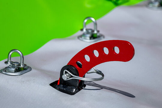 Agricultural disc mower protective curtain steel latch handle. Modern farming forage harvester canvas cover selector lever component with linch pins and industrial mechanism technical details.