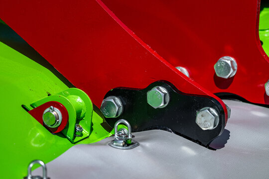 Agricultural disc mower frame heavy bracket bolt joint assembly. Modern farming forage harvester steel machine chassis construction hardware component with linch pin and mechanical technical details.