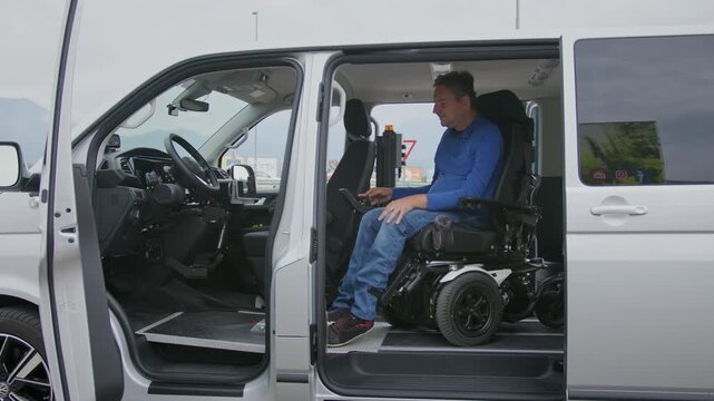 Wheelchair user preparing to drive directly from a powered wheelchair inside an adapted van designed for independent mobility.