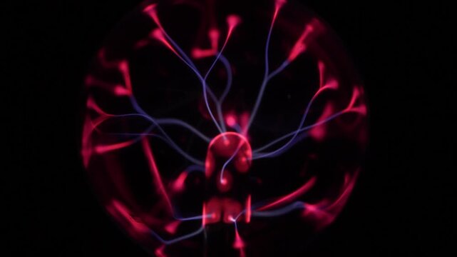 Close-up of the plasma ball in operation. The discharge color is shades of red and purple.