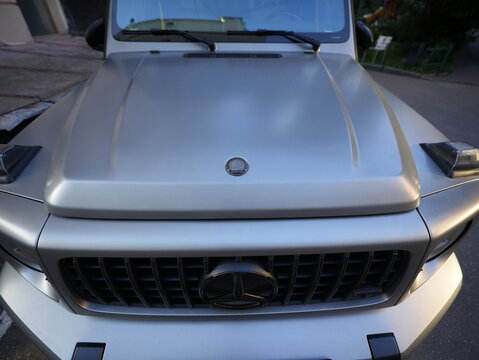 Mercedes-Benz G63 AMG Gel&auml;ndewagen silver luxury SUV front view showing iconic grille, hood design and premium automotive styling