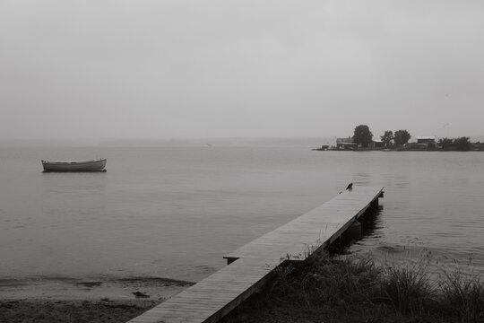 Wooden pier and boat on calm water