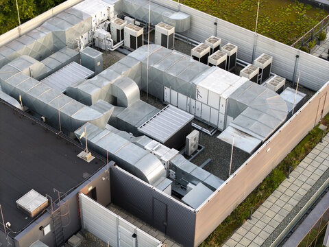 Aerial view of the HVAC cooling system for an AI data center, featuring industrial ventilation ducts and cooling units on a modern building rooftop in Krakow, Lesser Poland Voivode, Poland.