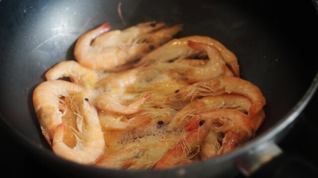 Tiger prawns fried in pan. Seafood. Shrimps cooking. Food prep.