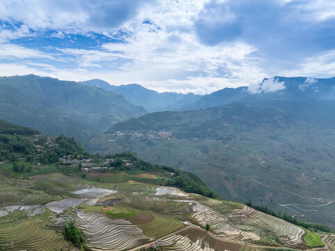 The pouring water season makes the terraced fields of Y Ty, Lao Cai province, Vietnam appear with brown soil blending with the beautiful sky