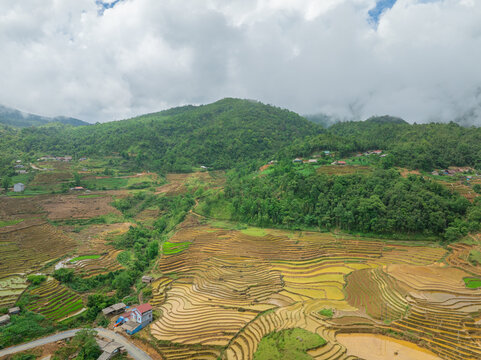 The pouring water season makes the terraced fields of Y Ty, Lao Cai province, Vietnam appear with brown soil blending with the beautiful sky