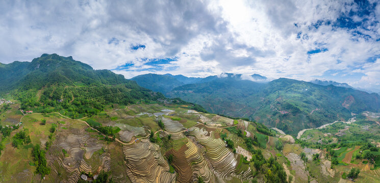 The pouring water season makes the terraced fields of Y Ty, Lao Cai province, Vietnam appear with brown soil blending with the beautiful sky