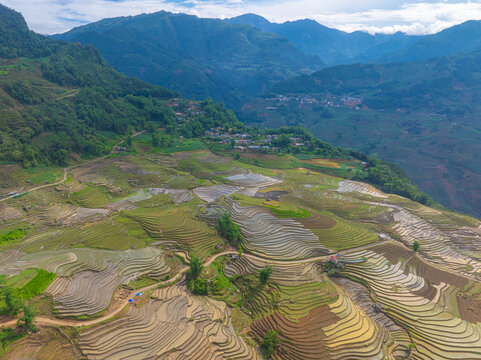 The pouring water season makes the terraced fields of Y Ty, Lao Cai province, Vietnam appear with brown soil blending with the beautiful sky