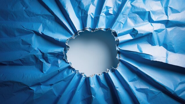 Crumpled Blue Paper with a Hole Revealing a Light Background