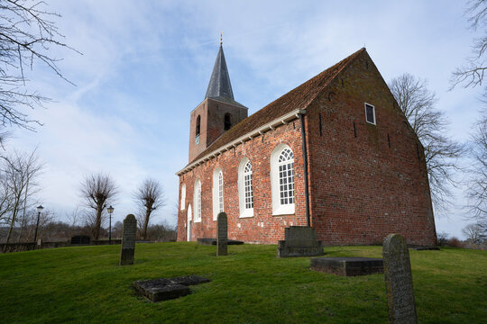 Eenum, province of Groningen, Netherlands, 2-2-2020. The Romanesque brick church on the mound dates from the 12th century and is owned by the Oude Groninger Kerken foundation. 
