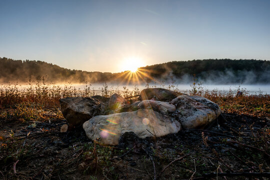 The sun shines over the foggy lake at sunrise. The sun shines through fog at sunrise, at Vlasina Lake, Serbia