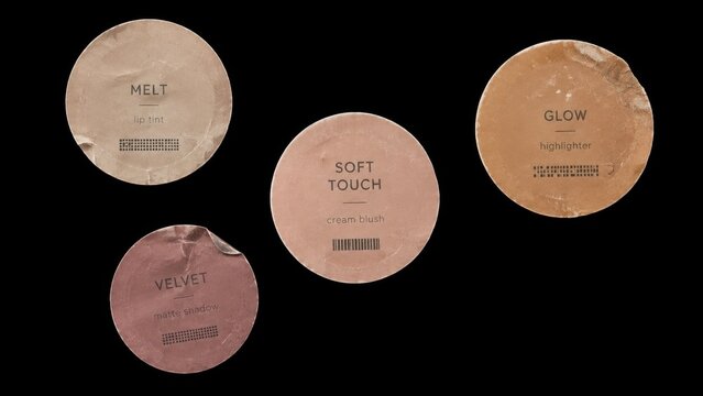 Four round cosmetic labels isolated on black background