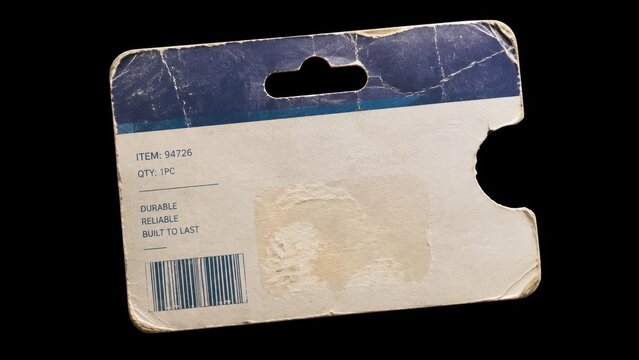 Worn cardboard product package card isolated on black