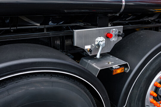 Semi truck trailer brake control valve panel block. Commercial transport vehicle pneumatic chassis section with release button and modern heavy duty cargo logistics engineering details.