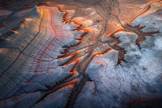 Aerial view of the striated rock formations of Kyzyl Kup, known as Tiramisu, featuring colorful geological layers and erosion patterns in Karakiya District, Mangystau Region, Kazakhstan.